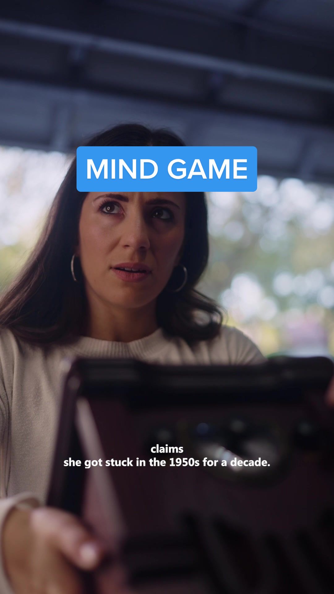 Still from Eliana Ghen's Mind Game TikTok, showing Eliana beneath the title Mind Game and a caption about being stuck in the 1950s